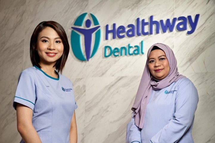 Healthway Dental Clinic staff standing in front of a Healthway Dental clinic in Singapore